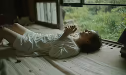 a girl laying down and taking a nap on the bed