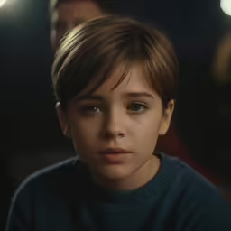 a close up of a person wearing a dark sweater