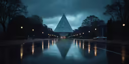 a large pyramid building lit up in the night