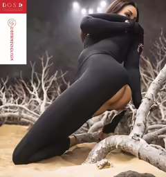 a woman in a black suit and some trees