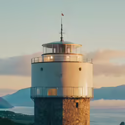 a light tower sitting on the top of a tall cliff