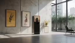 a wall with paintings and a chair in it