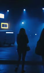 two people standing on top of a dark parking lot