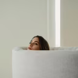 an image of a woman laying down on the couch