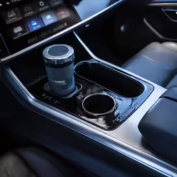 the center console in a car showing the cup holders