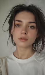 a woman with long dark hair wearing white shirt