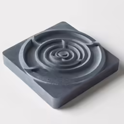 an artisticly constructed concrete sculpture featuring waves and a spiral design