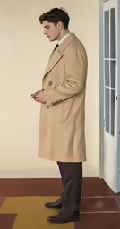a man with his hand in his pockets looking down