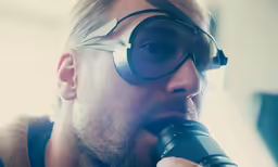 a man wearing goggles while holding a camera