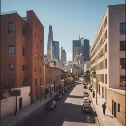 looking down a city street at some tall buildings