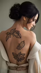 a woman with a tattoos on her back