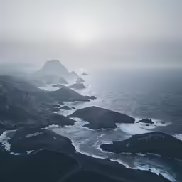 an aerial view of the coast and rocks on a cloudy day