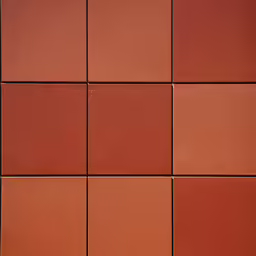 an orange tiled wall with different shades of tile