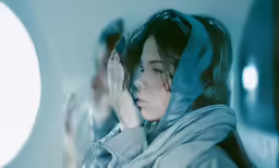 a woman in grey jacket with a concerned look on her face