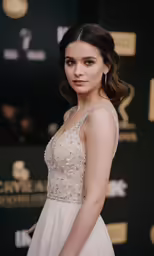 a woman in white dress posing for the camera
