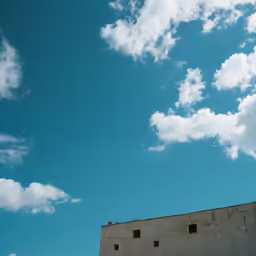 a building with an airplane in the sky