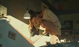 a woman is sticking her face up on top of the wall