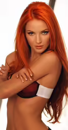a red headed girl with long hair poses with her arms around her waist