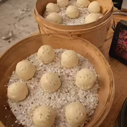 a couple of wooden buckets filled with rice