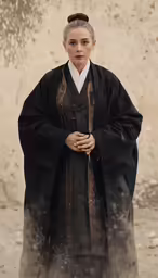 an old fashion woman in a black robe and white collar