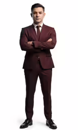 a man in a suit and tie posing with his arms crossed