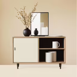 a white and black cabinet with vases and mirror