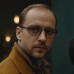 a close up of a person with glasses