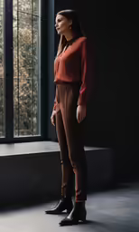 woman standing in front of a window with a black background