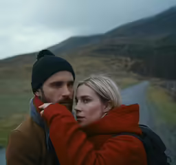 a man and a woman posing on the road