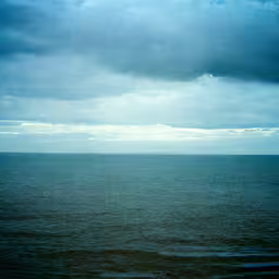 a very large body of water on a cloudy day,view from a large body of water on a cloudy day