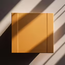 an empty yellow paper box that is standing up against the wall
