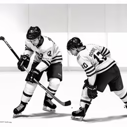 two men playing hockey while wearing jerseys