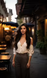 a woman in a white top is standing outside