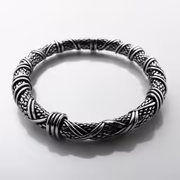 this silver - colored bracelet has a twisted wire on the clasp