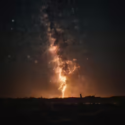 this is a nighttime scene with a bright fire crack in the sky