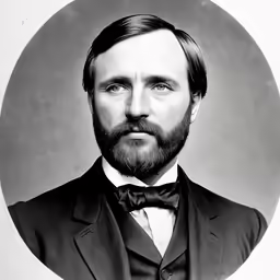 a bearded man wearing a suit and bow tie
