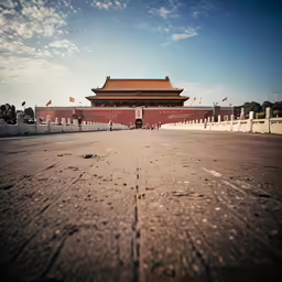 a lone car parked in front of a red gate
