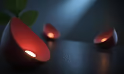 two red vases on top of a table and two lights
