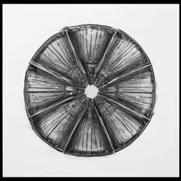 a black and white photo of an architectural object in its center