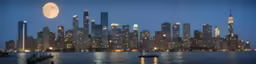 the view of a city at night through the water