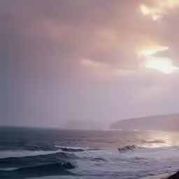 an umbrella is on the beach near a cliff