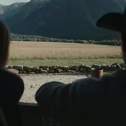 a woman looking out the window of a cabin