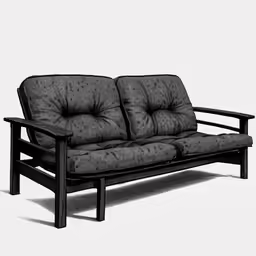 a black couch is sitting on a white surface