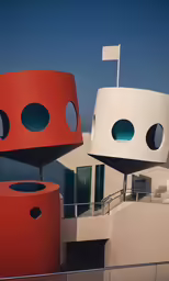 two red round structures sit near the ocean