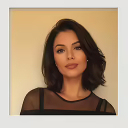 a woman wearing black in front of a beige background