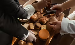 a couple are exchanging rings in front of bread
