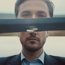 a man is staring down from behind a railing
