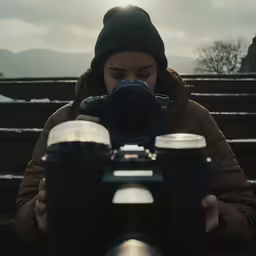 a man taking a picture while looking through binoculars