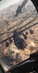 a helicopter flying over a large mountain range