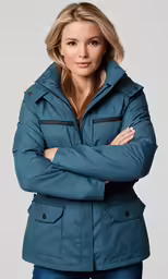 the woman in blue jacket poses with her arms folded